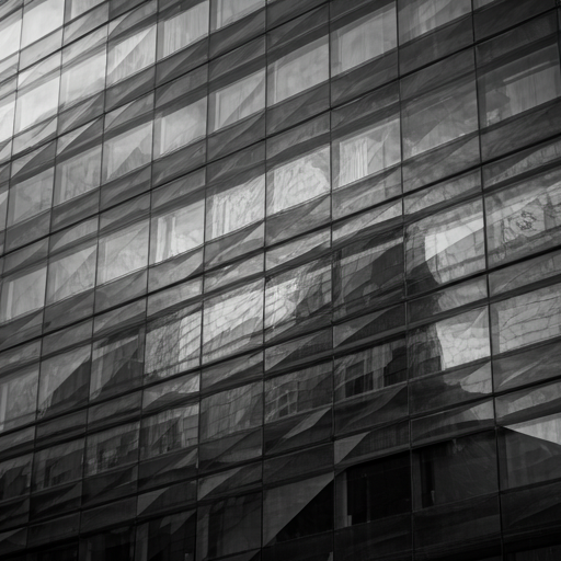 Monochrome glass tower facade with layered, abstract reflections